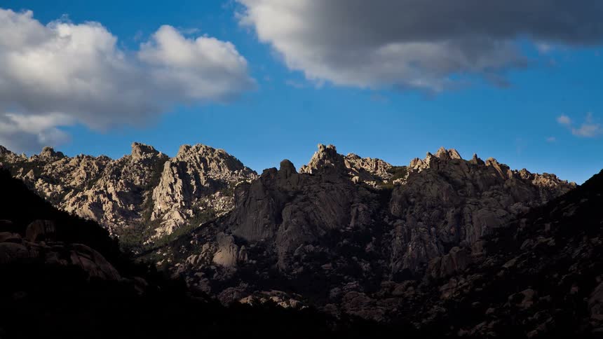 Clouds float over a mountain ridge
