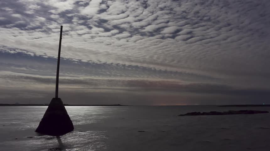 Time-lapse of clouds passing over some calm waters