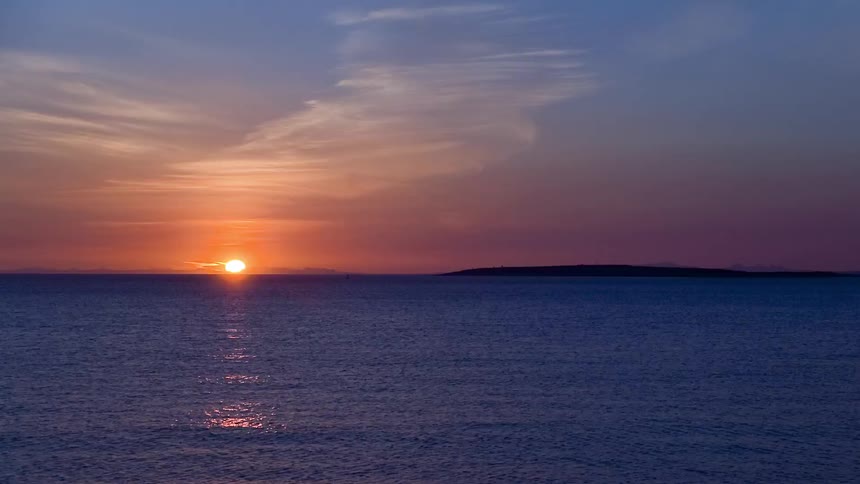 The sun sets over a lake