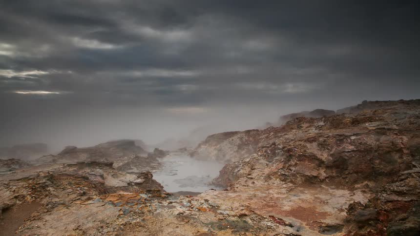 The wind is blowing the clouds over the rocks