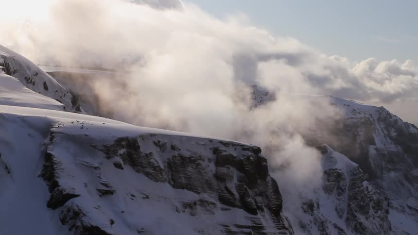 The clouds slowly move up the mountain