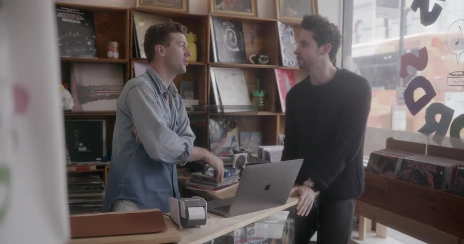 A record store worker talks to another man