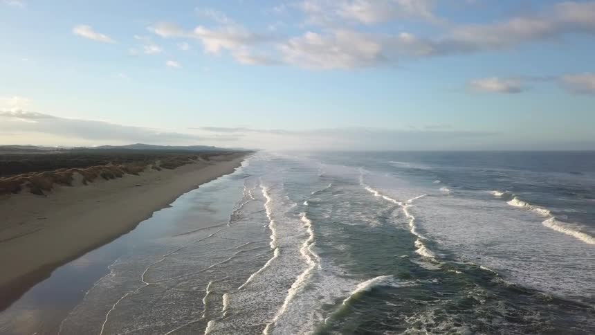 Ocean waves wash ashore a beach