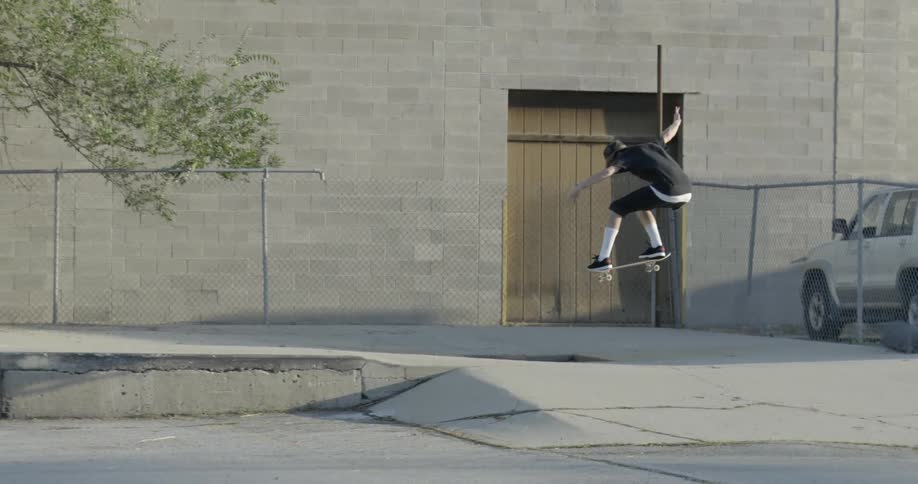 Man does a jump while riding a skateboard