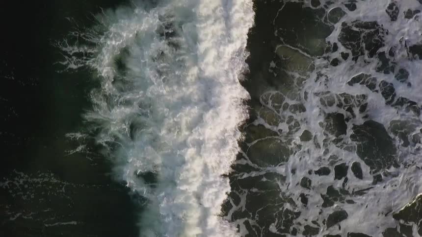 Ocean waves splash and foam as they come to shore
