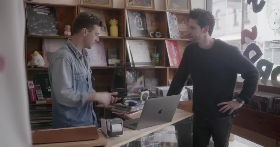 A record store worker talks to another man