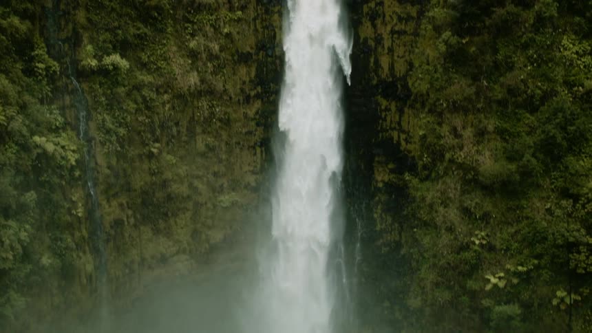 A waterfall flows over a cliff