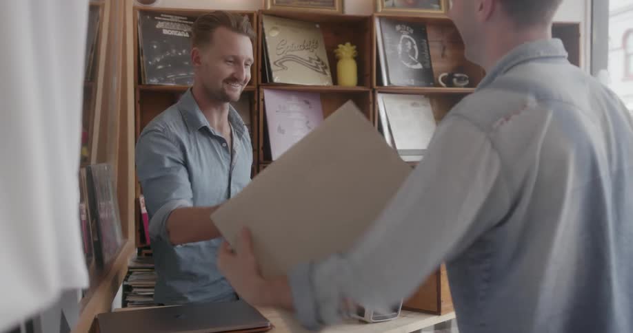 A man pays for a record album with a credit card