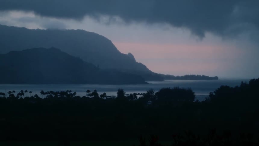 Clouds float over a mountain lake at sunset