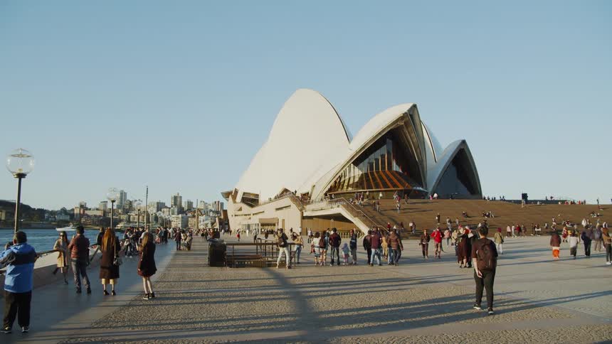 People walk along the city pier