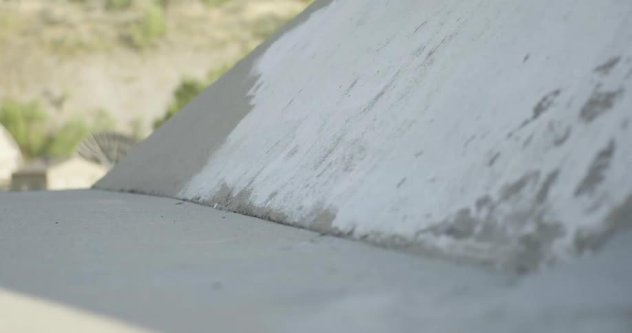 Skateboarder going up a concrete slope