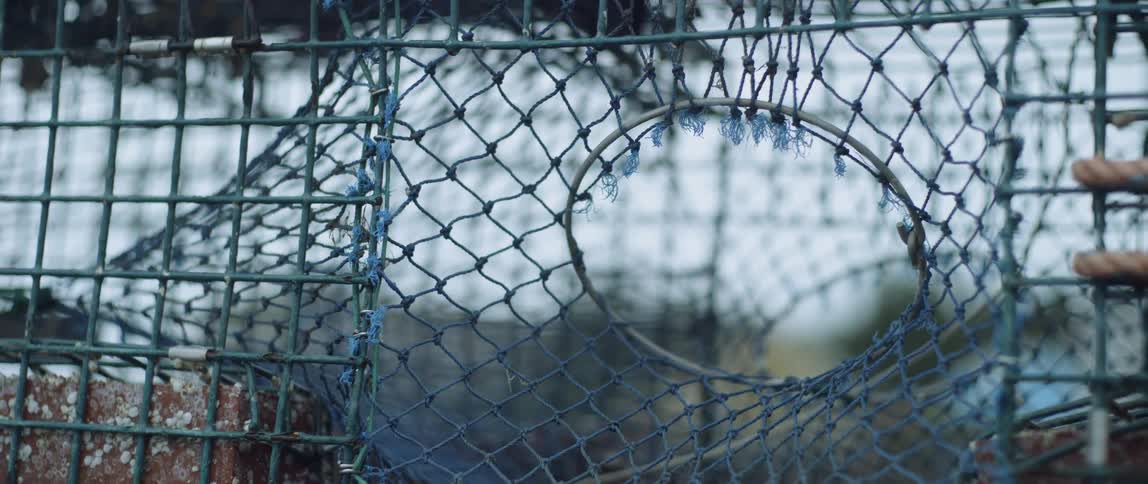 The cage is made of rope and metal