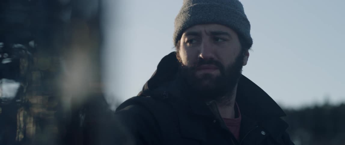 A man in a hat looks around