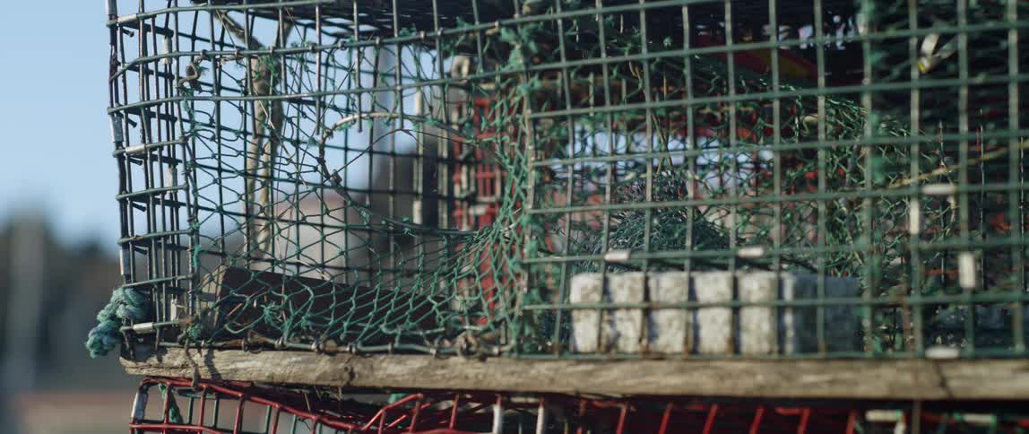 A man walks by fishing cages
