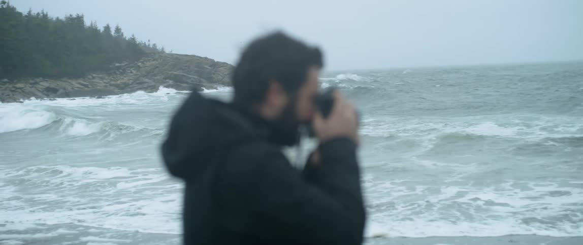 A man photographs the ocean