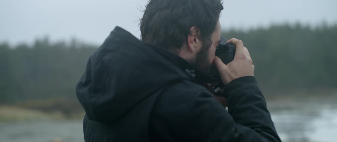 A man is taking pictures of the ocean waves