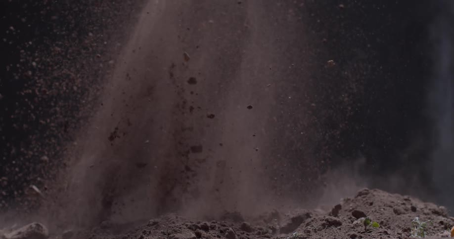 Dirt and rocks explode and then settle
