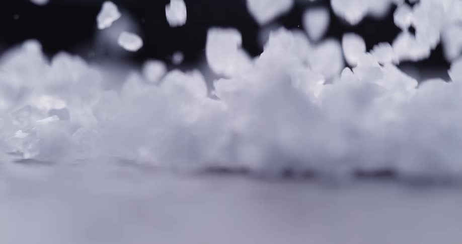 Small white crystals fall down on the surface