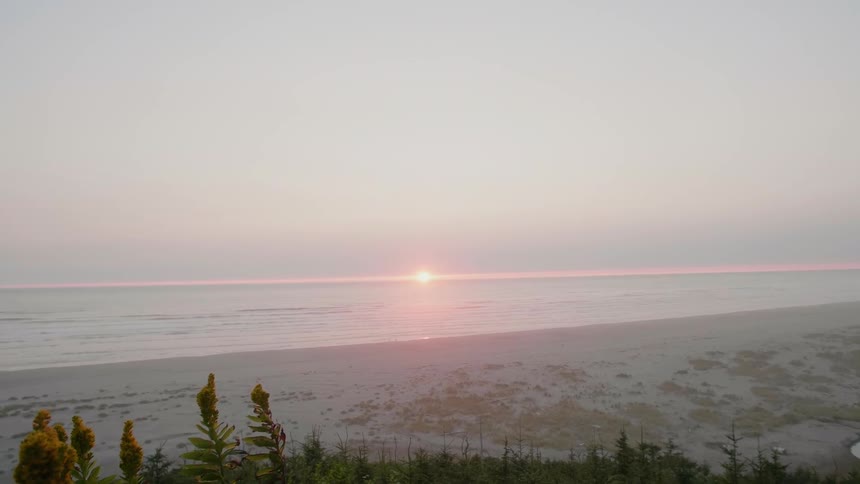 The sun sets on the ocean horizon