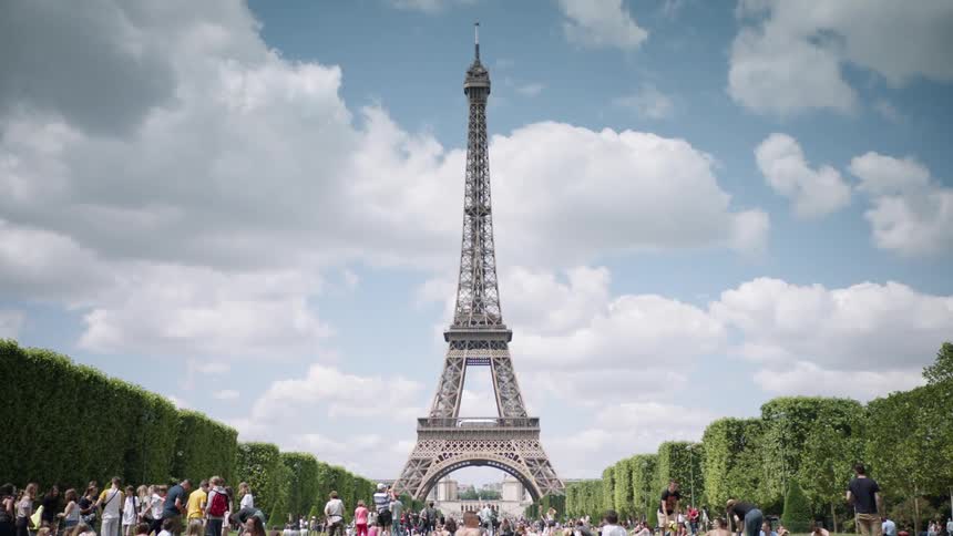 Tourists observe and photograph the eiffel tower