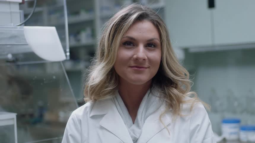 A woman is looking at the camera and smirking