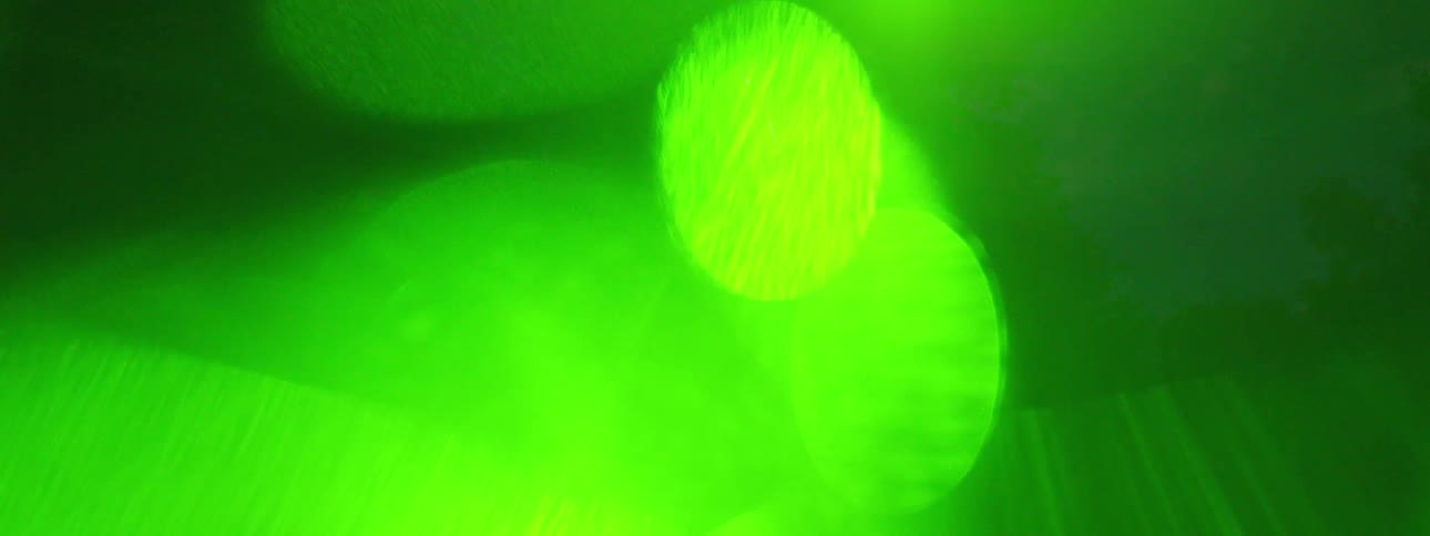 Strobe lights flash through smoke