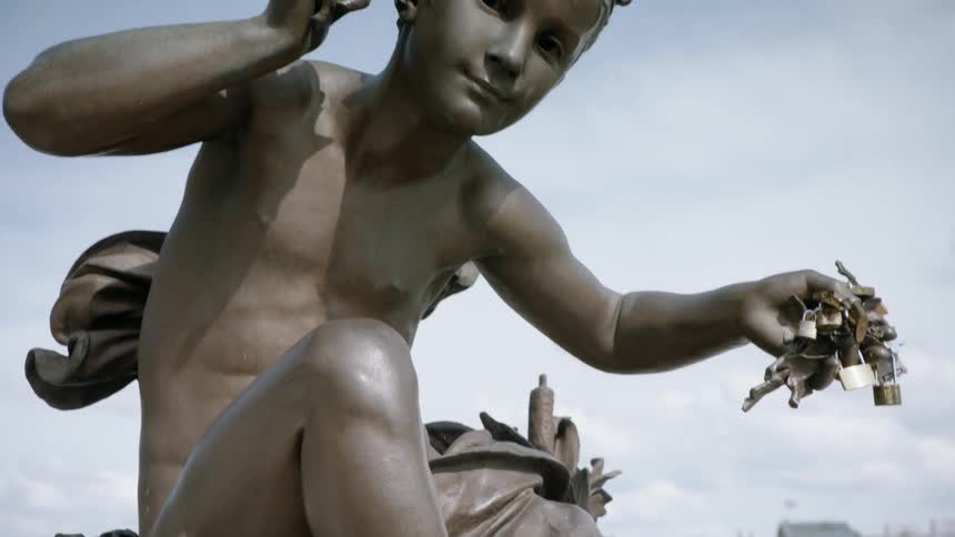 Padlocks cover a statue's hand
