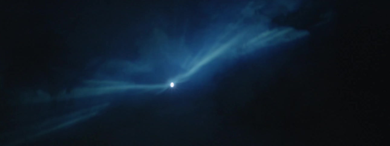Light flashing through smoke in the darkness