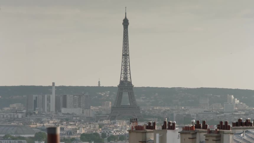 Eiffel tower standing high on a cloudy day