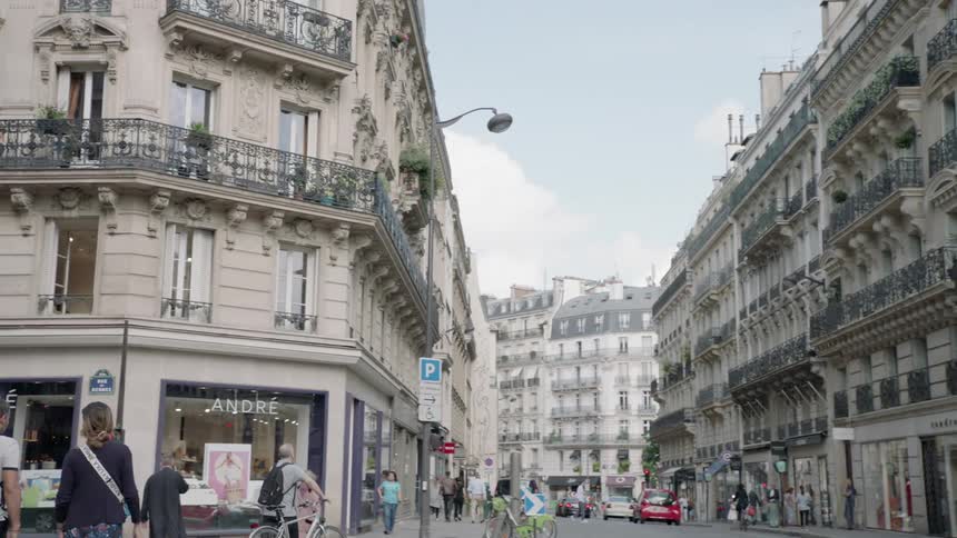 Pedestrians and vehicles commute through a city