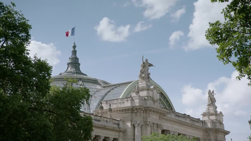 Building with statues as decoration against a cloudy sky