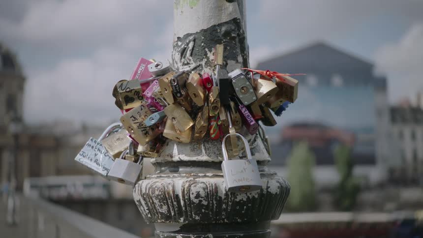 Close up of locks attached to a pole in paris france