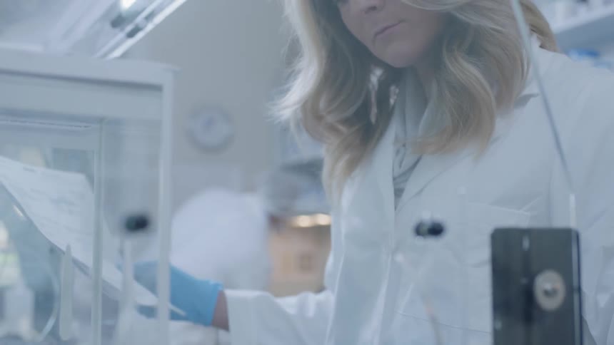 A woman uses lab equipment in a medical lab