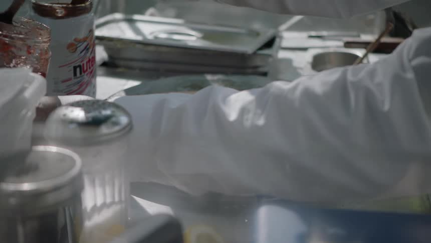 A person cooks on a hot plate