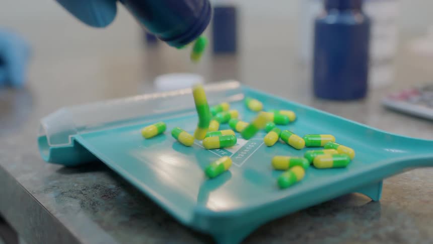 Pills are poured onto a tray