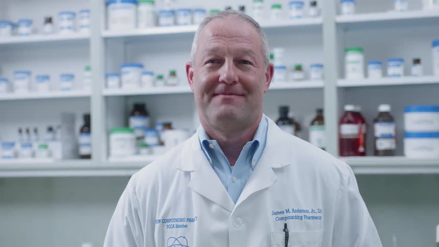 A pharmacist smiles