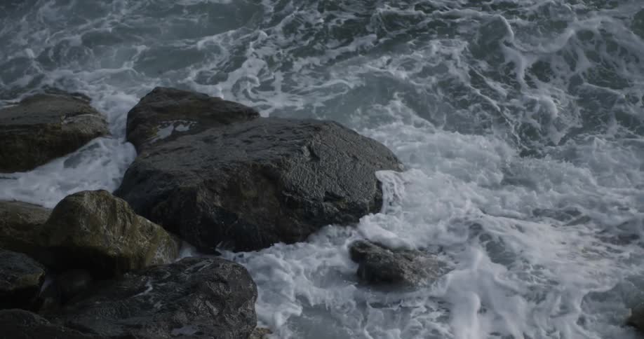 Ocean waves crash into rocks