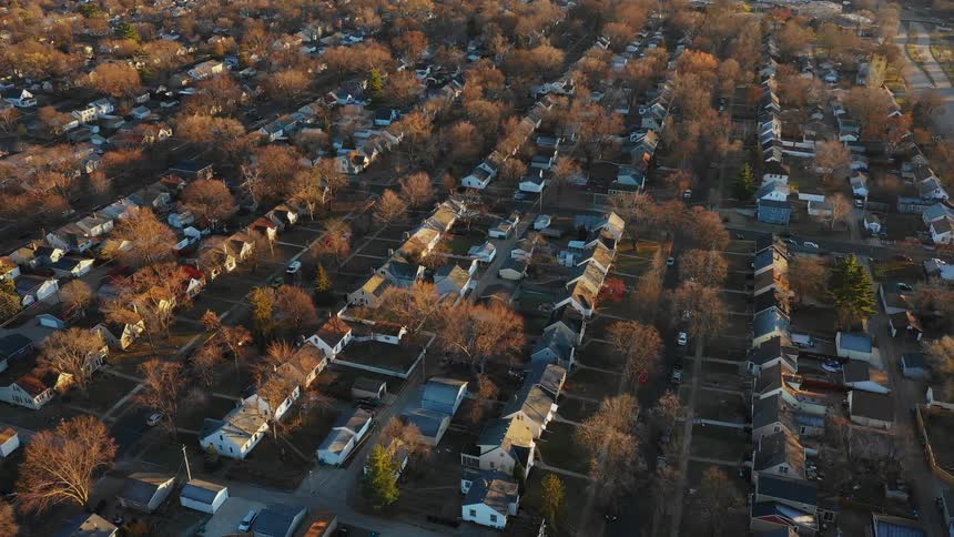 Autumn trees surround houses in a neighborhood