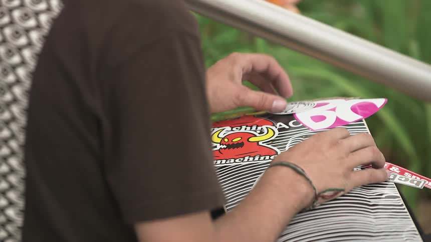 Man sorting some decals in front of him
