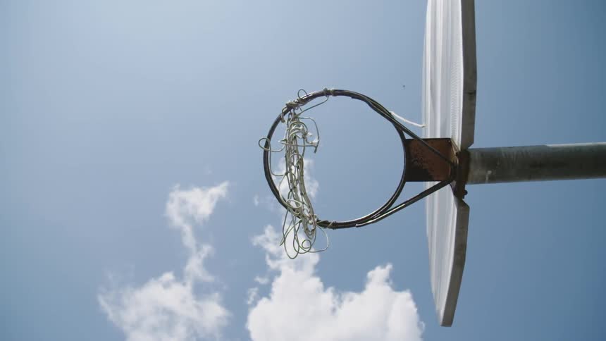 Clouds float above a basketball hoop