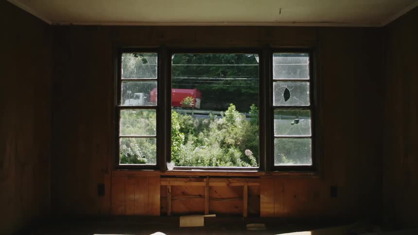 A semi-truck is seen driving from a home interior