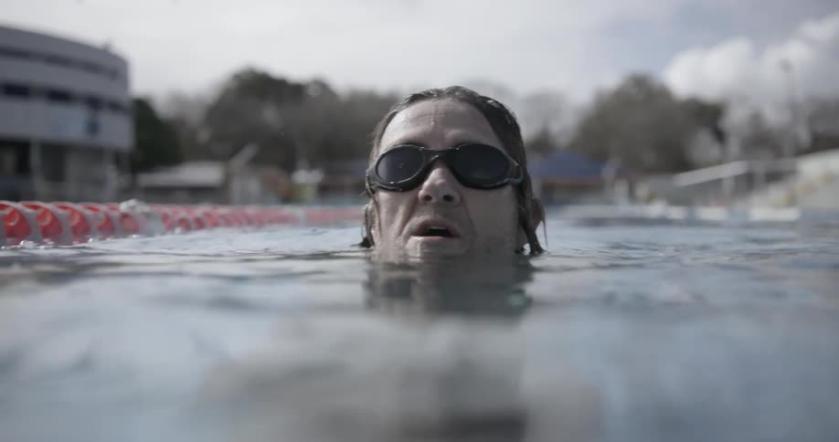 Man swims in a swimming pool