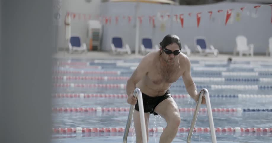 A swimmer exits a lap pool