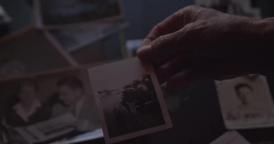 Person looking at old photo of men dressed in military uniforms