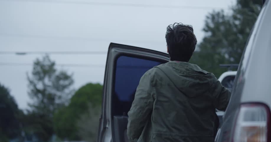 Man climbs out of a parked car