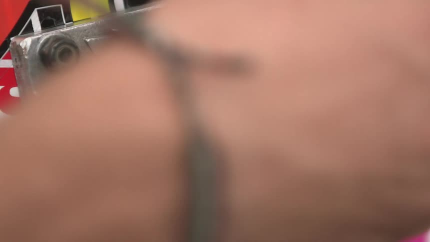 Close up of a man fiddling with his skateboard truck