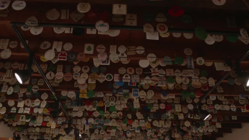 Patches and badges on display as they hang from beams from the ceiling