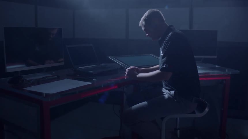 Man sits thinking at a desk
