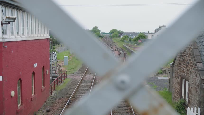 Train tracks extend past an old depot