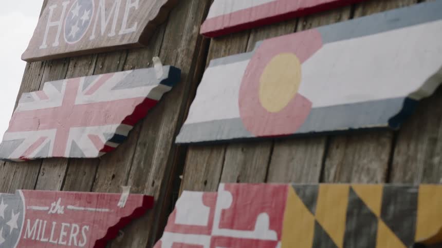 There are wooden signs with flags all over the wall